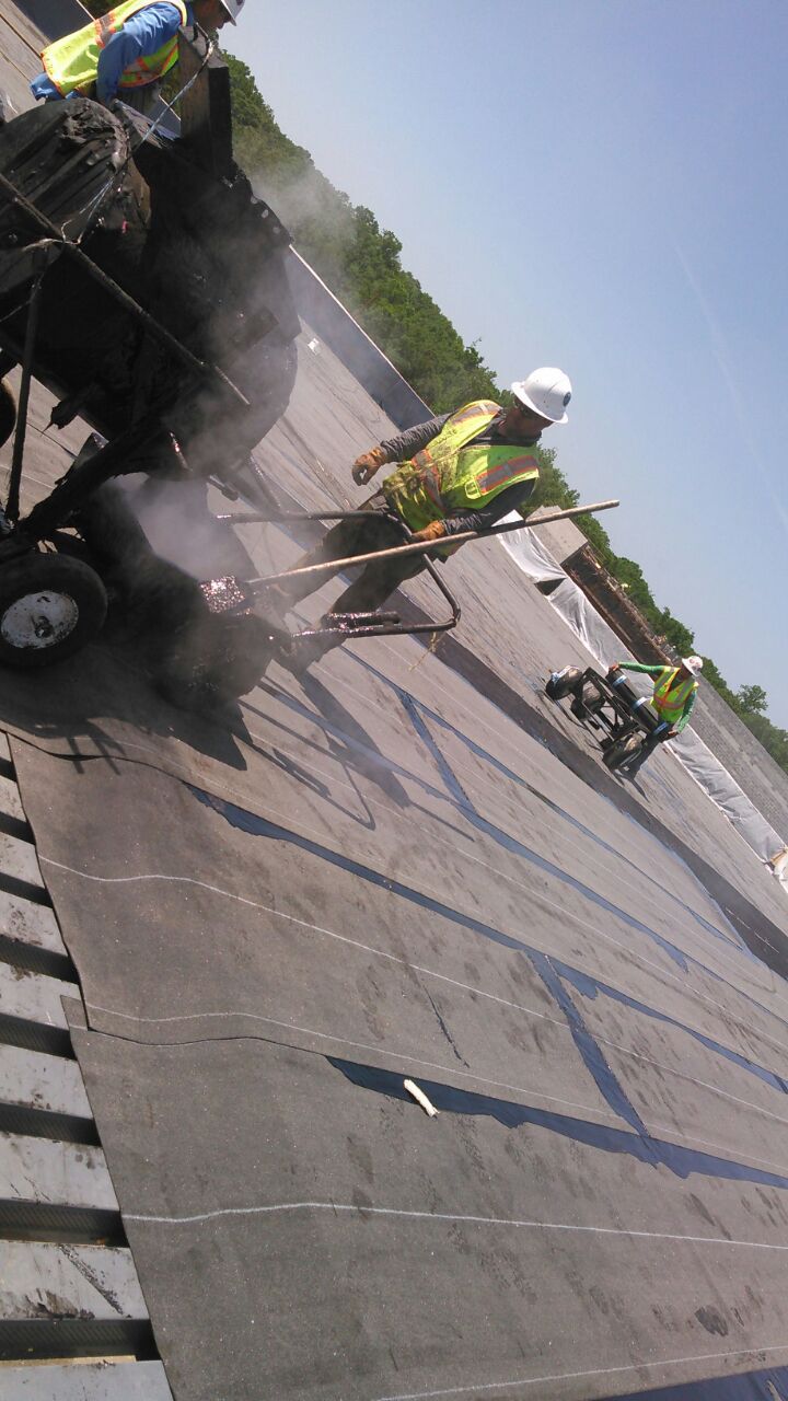 United Roofing LLC team on commercial flat roof Houston TX